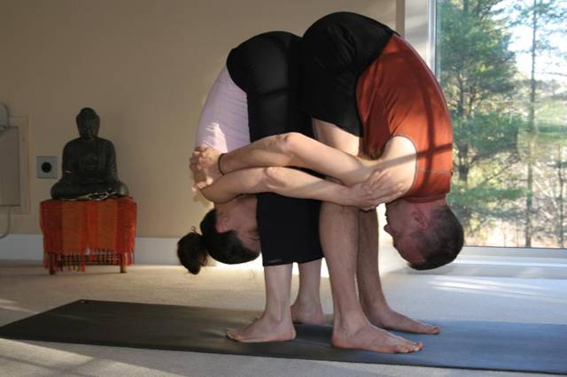 double standing forward bend yoga position