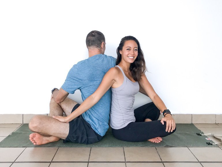 A Couple in twist yoga pose
