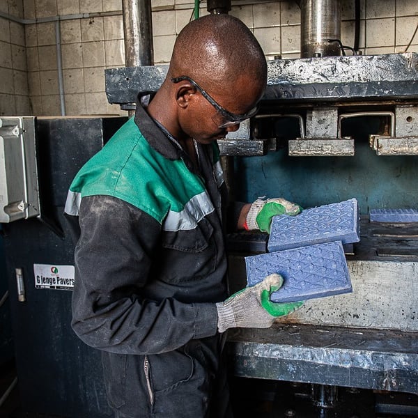 An employee of the Kenyan woman startup inspecting the plastic bricks