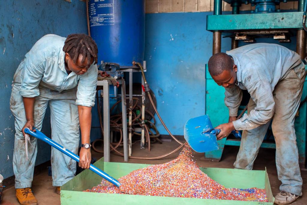 Kenyan woman startup team working on the raw materials of plastic bricks