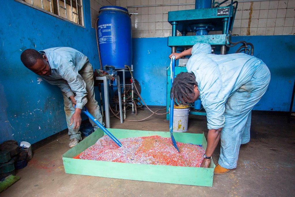 Kenyan women startup employees working on shredded plastic