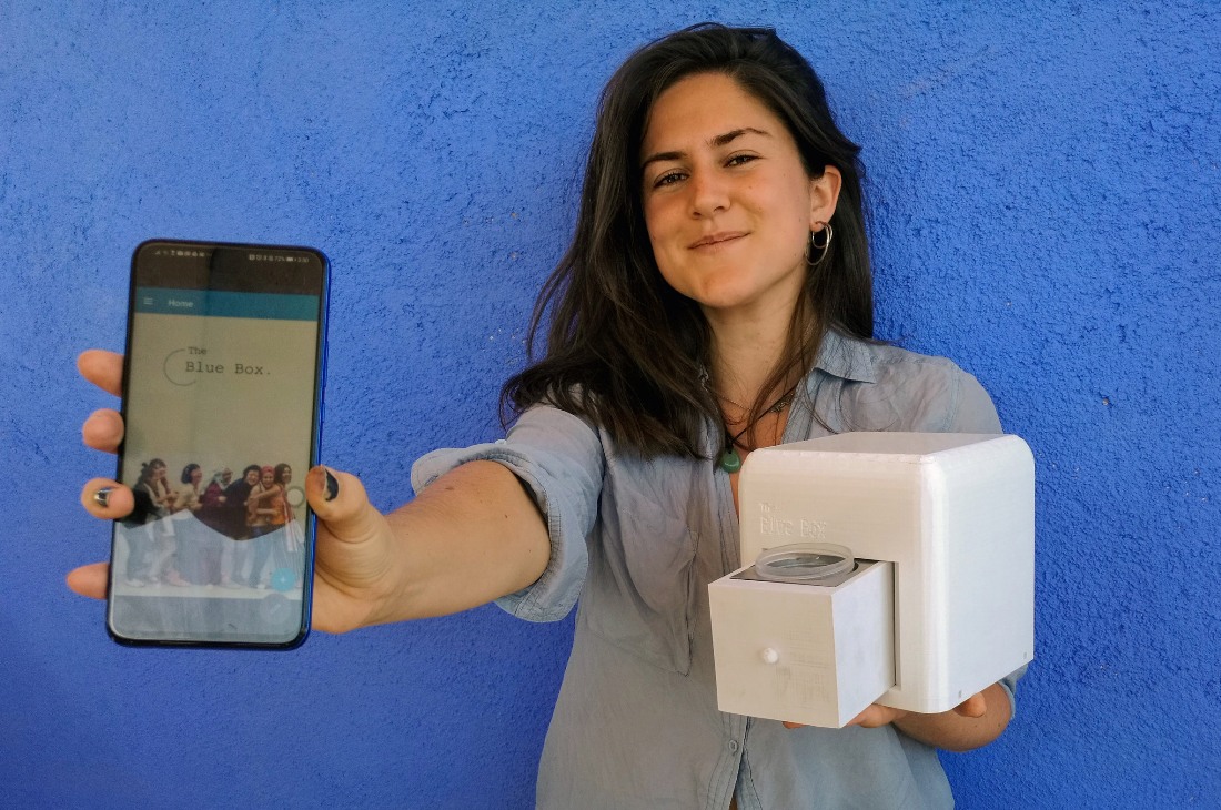 Women holding Blue box gadget