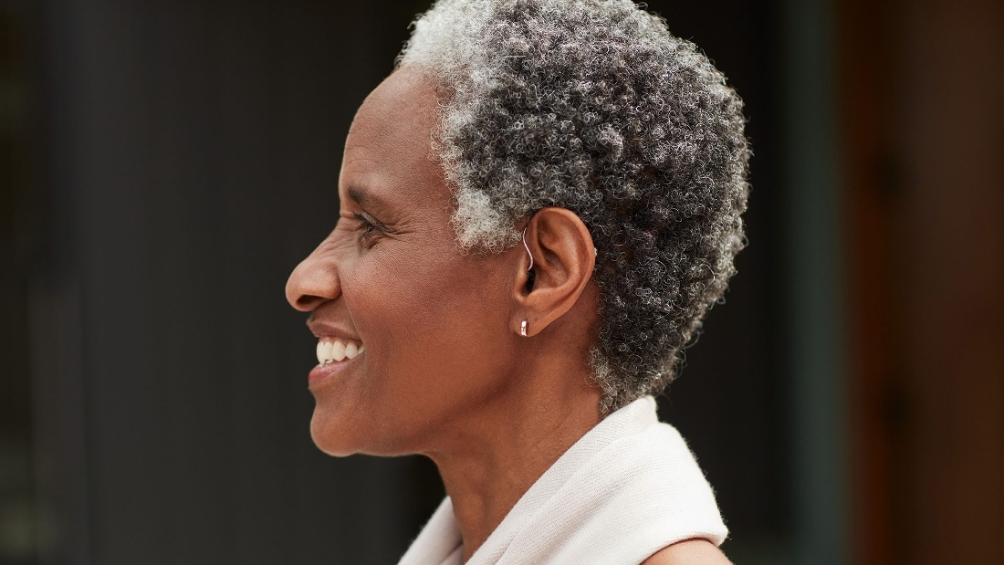 A lady wearing Bose self-fitting hearing aid