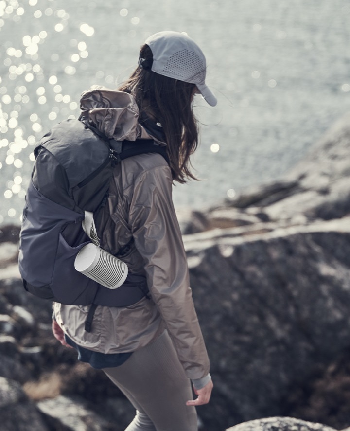 Beosound Explore Speaker attached to a hiker's backpak