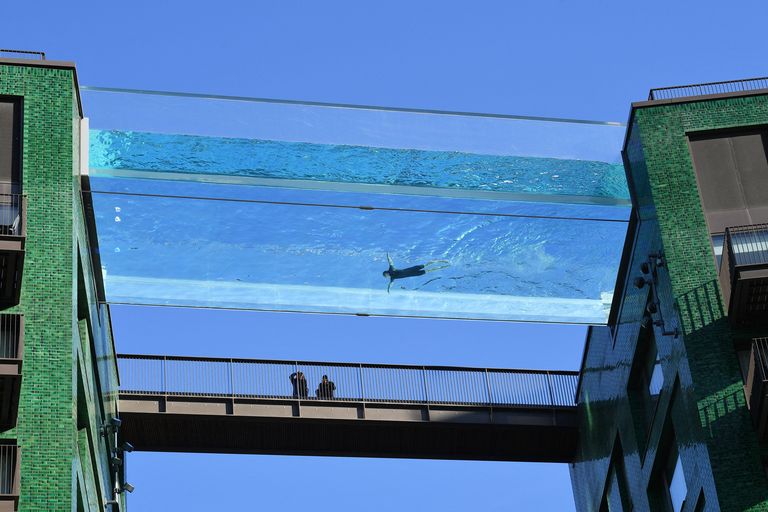 People walking below the suspended Sky pool