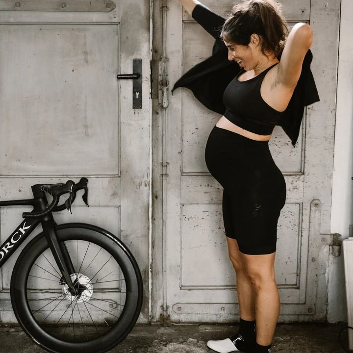 A pregnant women wearing Veloine cycling gear