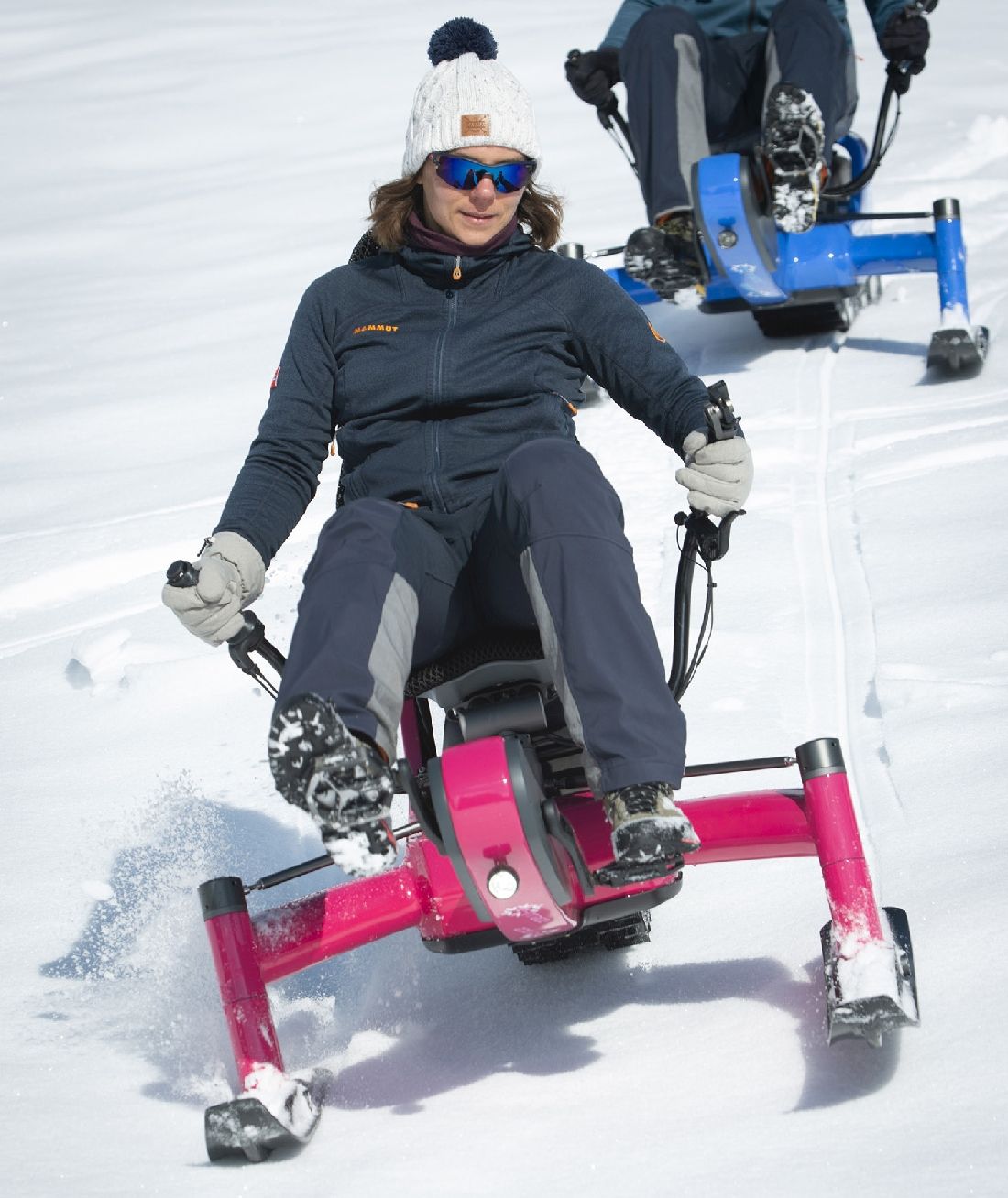 A women riding Arosno E-trace Electric snow bike