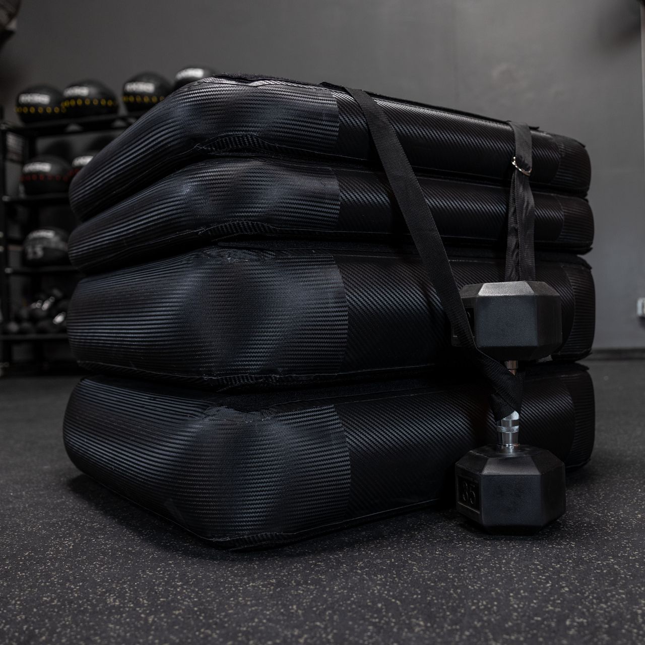 Dumbbell strapped to Rx Smart Gear plyo box