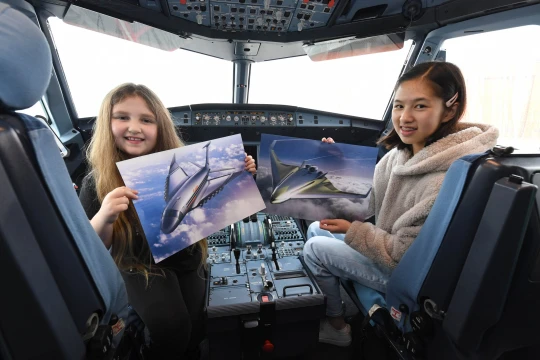 Cerys Armstrong and Lara Wong inside a plane cockpit