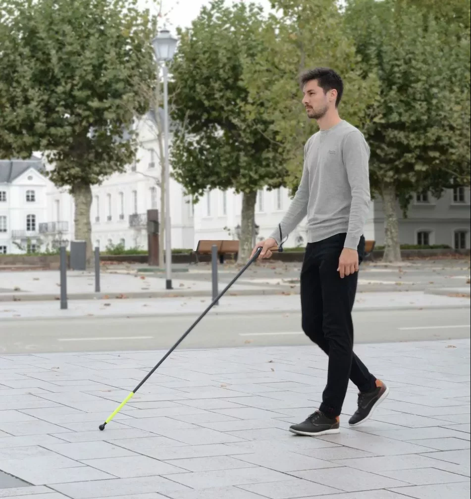 A blind man walking with Orto cane