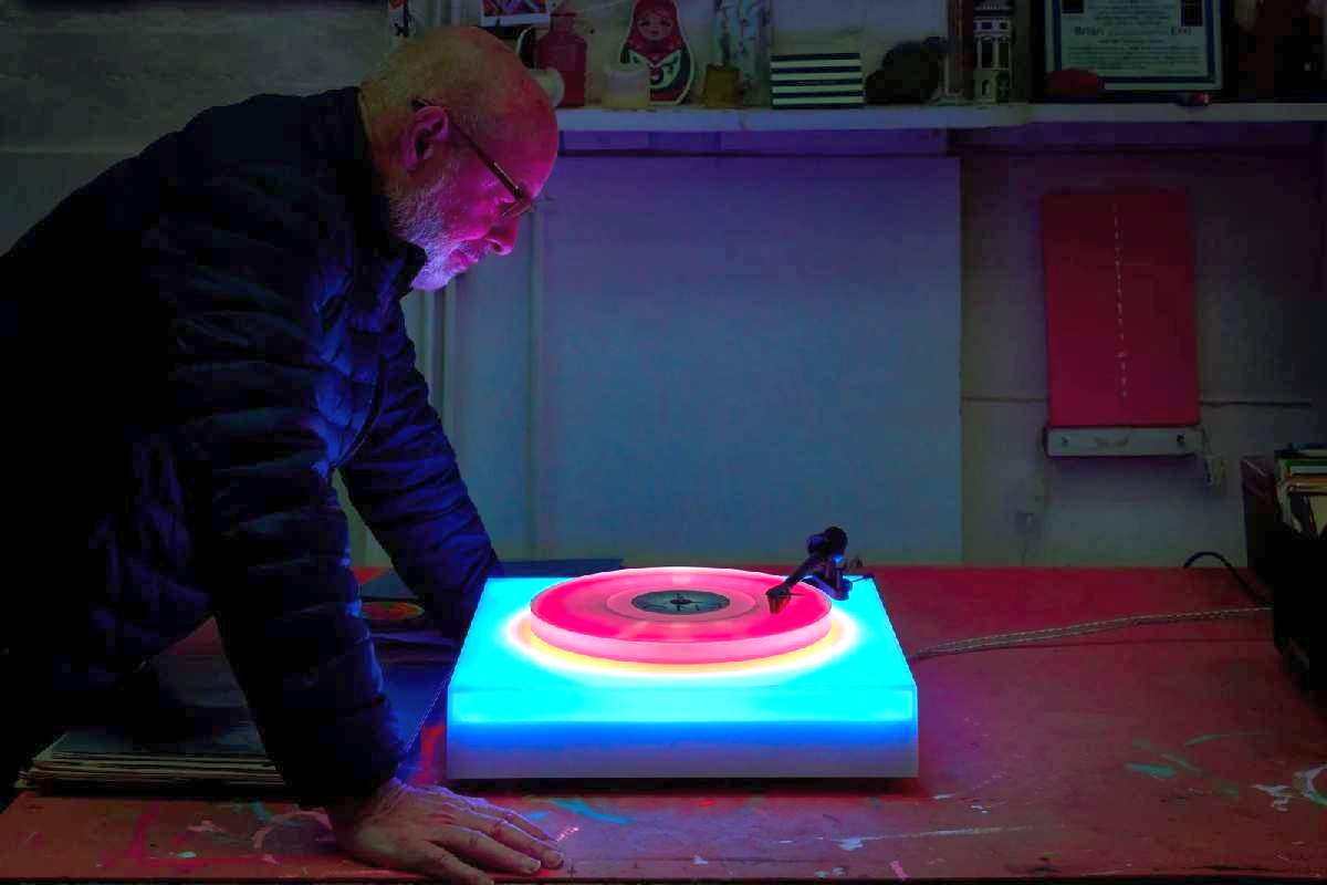 Brian Eno looking into his LED turntable