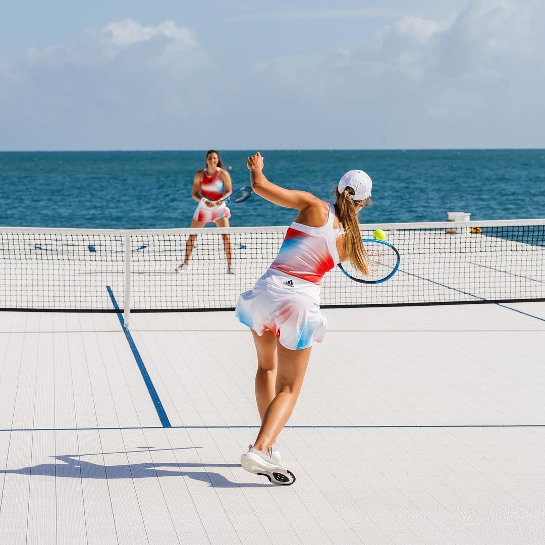 Girls playing on adidas tennis court floating on great barrier reef