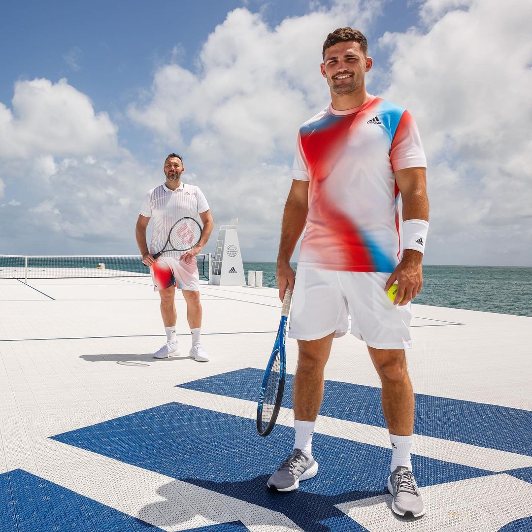 Sportsmen standing on floating tennis court