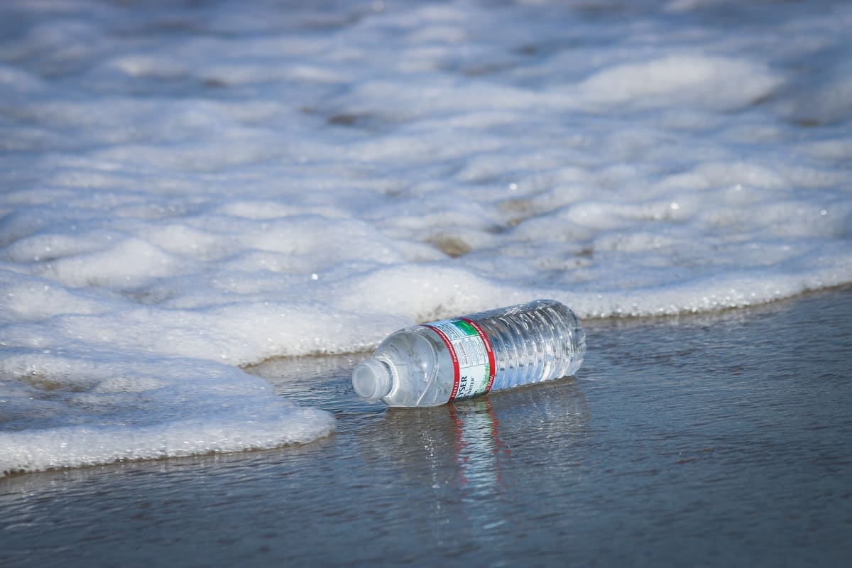 A plastic bottle lying by sea shore